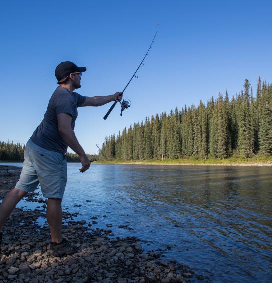 Visitor casting in the Kakisa River