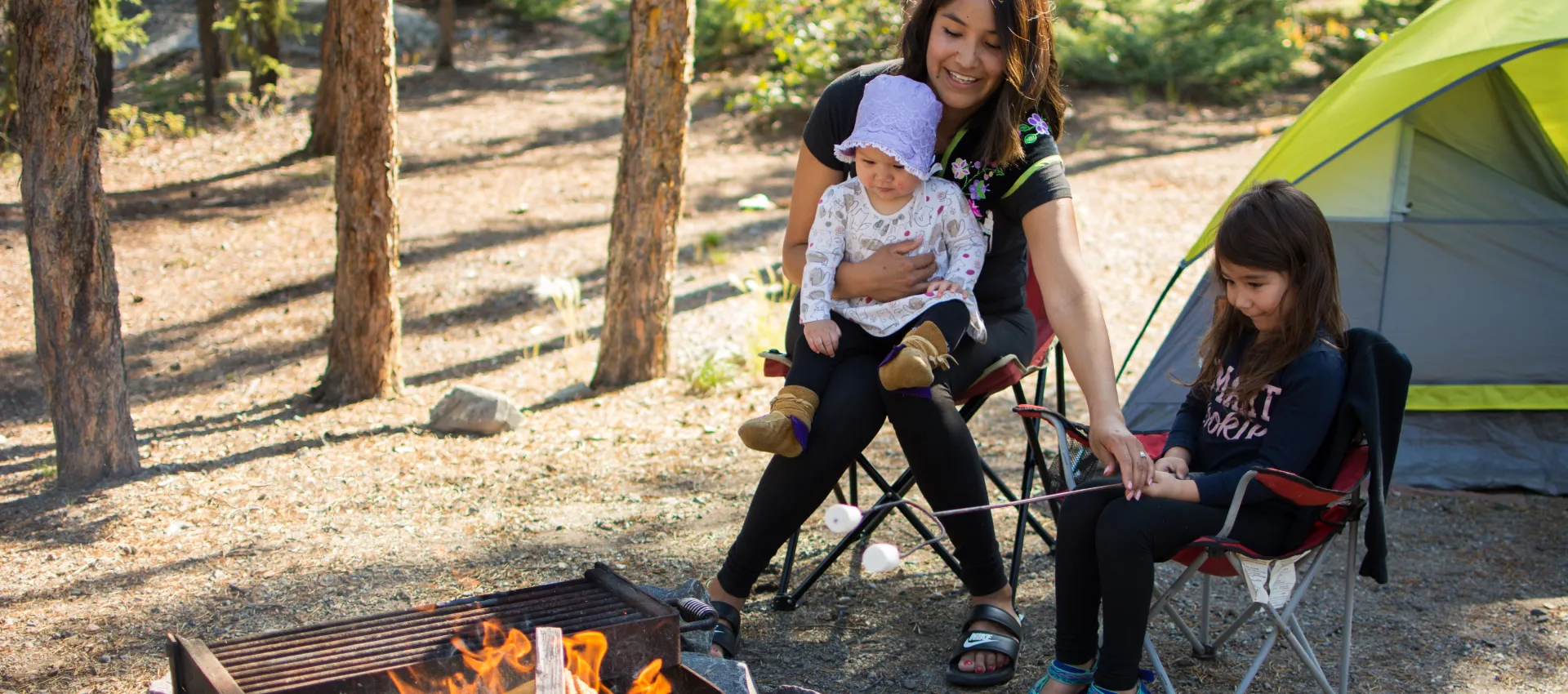 Family by a campfire tent