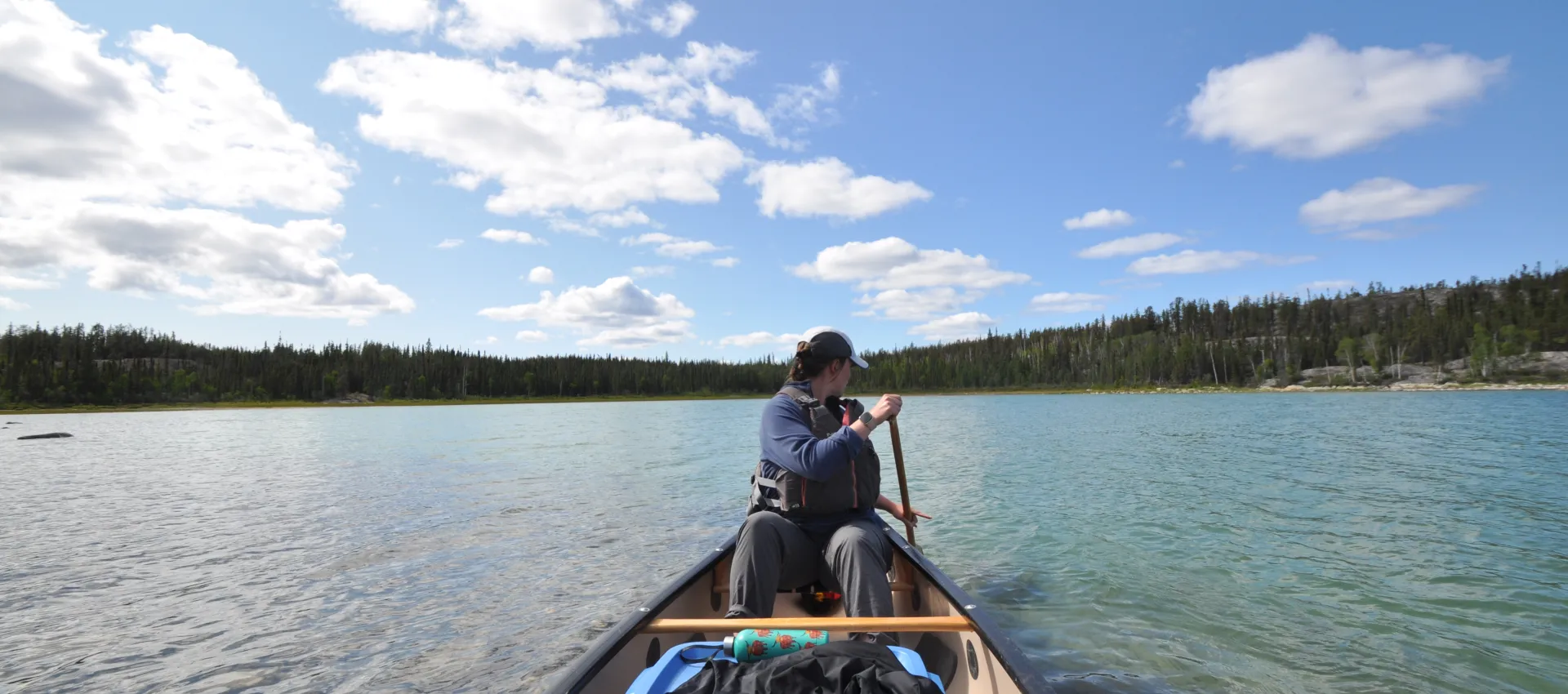 Canoeist paddling on Hidden Lake looking backwards