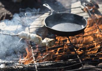 Cooking bannock over a campfire